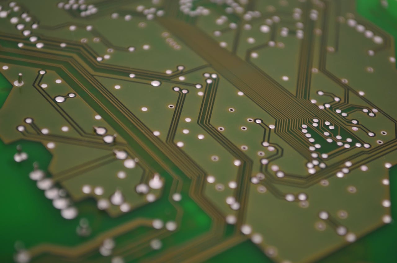 services-01 Detailed view of a printed circuit board showcasing intricate chip connections and pathways.