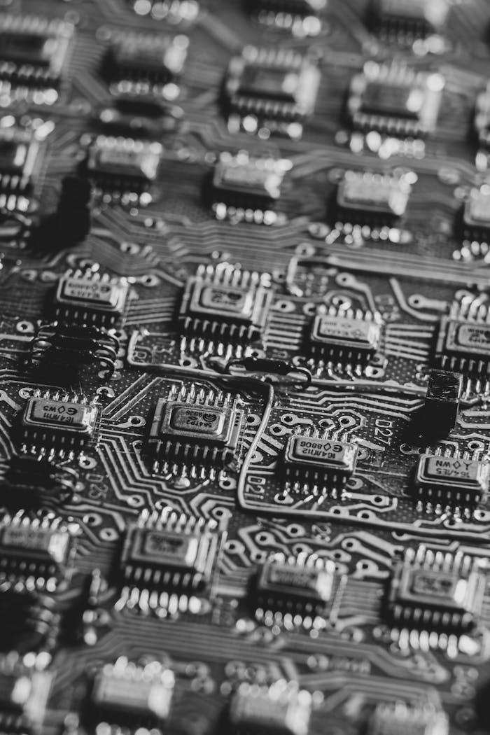 services-02 High-detail black and white image focusing on microchips on a circuit board.